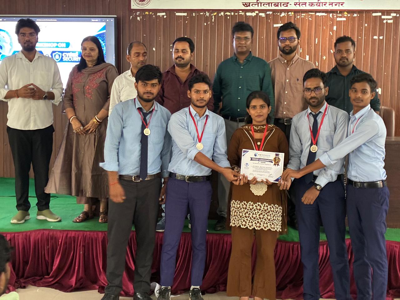 A team holding their group assessment certificate at a KeyCode workshop