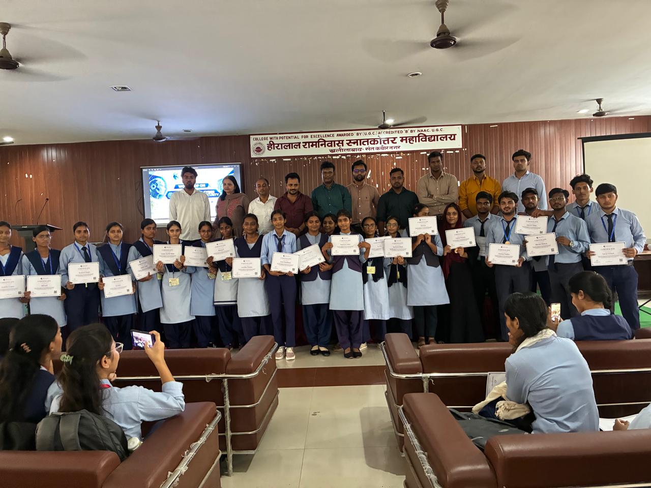 Students on stage holding their KeyCode participation certificates