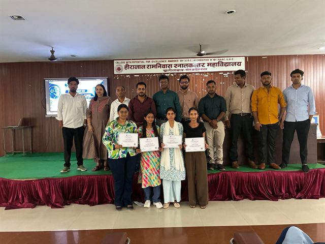 Four students holding participation certificates that carry a QR code