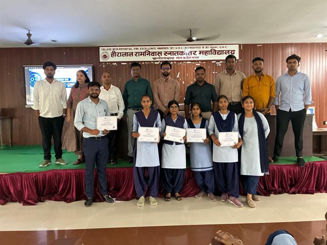 Students holding their certificates, with faculty and organisers behind them
